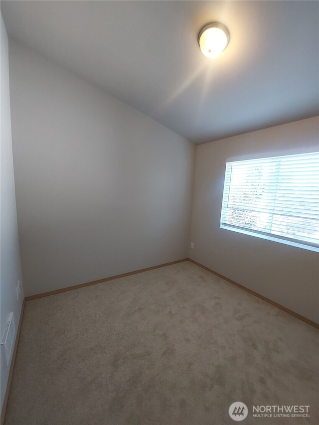 6907 Rainier Dr E Unit 1B, Everett, WA 98203 - spare room featuring light carpet and baseboards