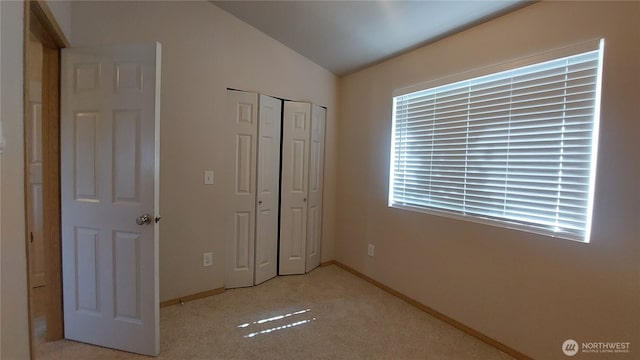 6907 Rainier Dr E Unit 1B, Everett, WA 98203 - unfurnished bedroom with lofted ceiling, a closet, and carpet flooring