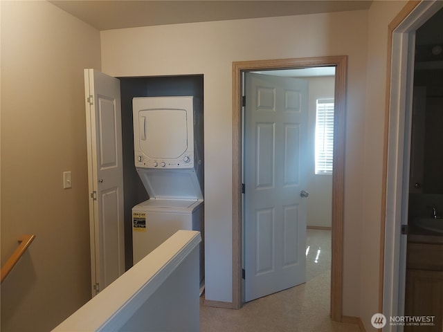 6907 Rainier Dr E Unit 1B, Everett, WA 98203 - laundry area featuring stacked washer and clothes dryer and light colored carpet
