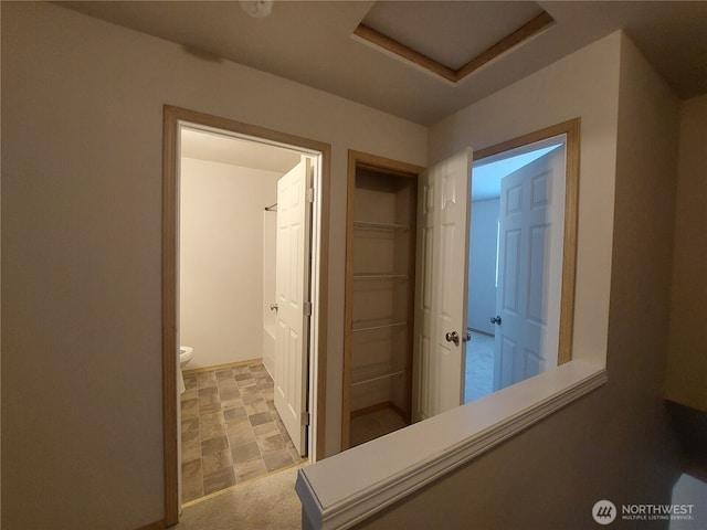 6907 Rainier Dr E Unit 1B, Everett, WA 98203 - hallway featuring attic access and baseboards