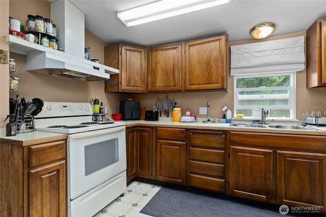 22517 133rd Street Ct E, Orting, WA 98360 - kitchen featuring electric range, brown cabinets, light countertops, and light floors