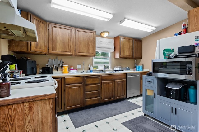 22517 133rd Street Ct E, Orting, WA 98360 - kitchen featuring appliances with stainless steel finishes, under cabinet range hood, light floors, and light countertops