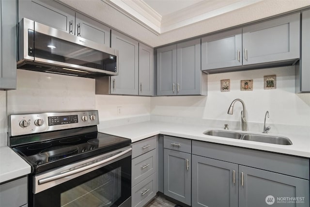 32710 5th Ave SW, Federal Way, WA 98023 - kitchen with stainless steel appliances, gray cabinets, light countertops, and ornamental molding