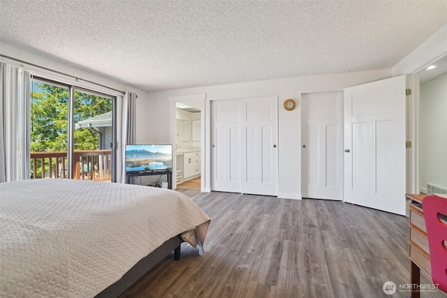 32710 5th Ave SW, Federal Way, WA 98023 - bedroom featuring access to outside, a textured ceiling, wood finished floors, ensuite bath, and multiple closets