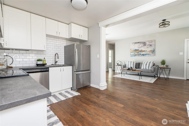 462 G St, Blaine, WA 98230 - kitchen featuring appliances with stainless steel finishes, decorative backsplash, open floor plan, dark wood finished floors, and white cabinetry