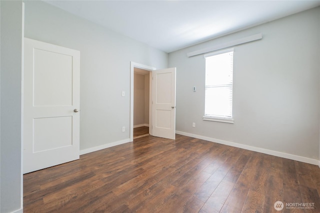 462 G St, Blaine, WA 98230 - unfurnished bedroom featuring baseboards and dark wood-style floors