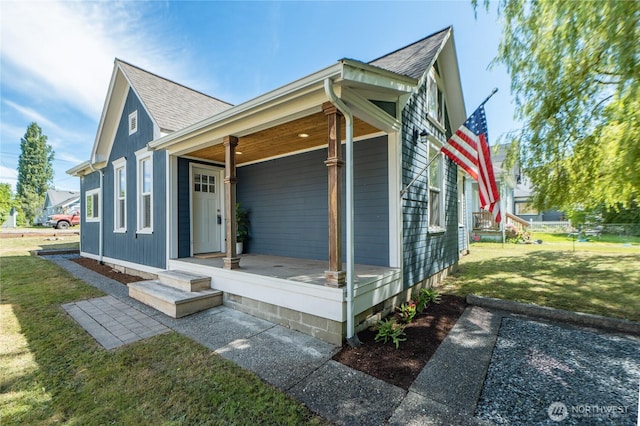 462 G St, Blaine, WA 98230 - view of side of home with a porch, roof with shingles, and a lawn