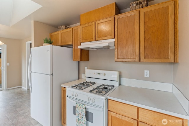 352 E Springfield Loop, Shelton, WA 98584 - kitchen featuring white appliances, under cabinet range hood, light countertops, and light tile patterned flooring