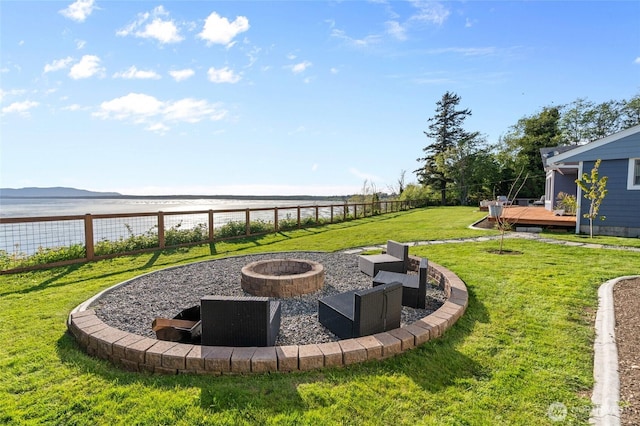 3161 Locust Ave, Bellingham, WA 98225 - fenced backyard featuring a fire pit and a deck with water view