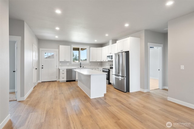 253 Kakela Rd, Winlock, WA 98596 - kitchen featuring stainless steel appliances, light countertops, white cabinetry, light wood-style flooring, and recessed lighting