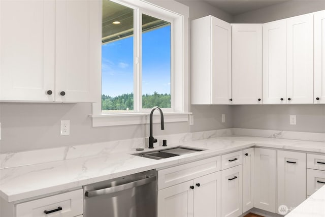 253 Kakela Rd, Winlock, WA 98596 - kitchen with stainless steel dishwasher, white cabinetry, and light stone counters
