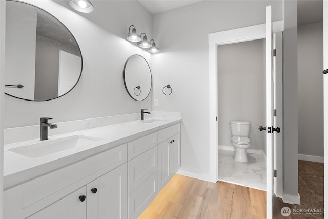 253 Kakela Rd, Winlock, WA 98596 - bathroom featuring double vanity and wood finished floors