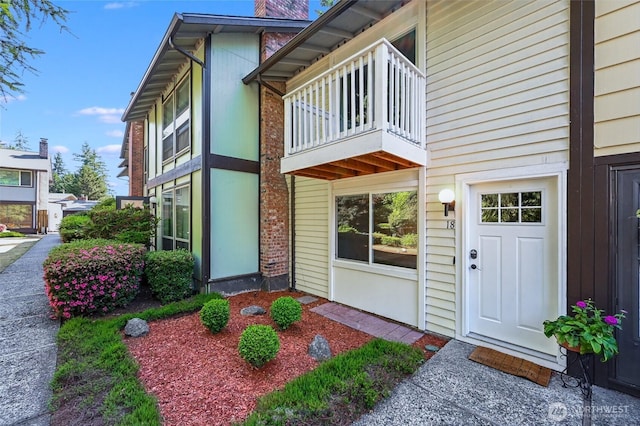 1717 150th Ave SE Unit 18, Bellevue, WA 98007 - property entrance with a chimney and a balcony