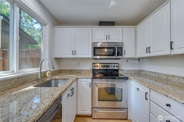 1717 150th Ave SE Unit 18, Bellevue, WA 98007 - kitchen featuring stainless steel appliances, white cabinets, and light stone counters