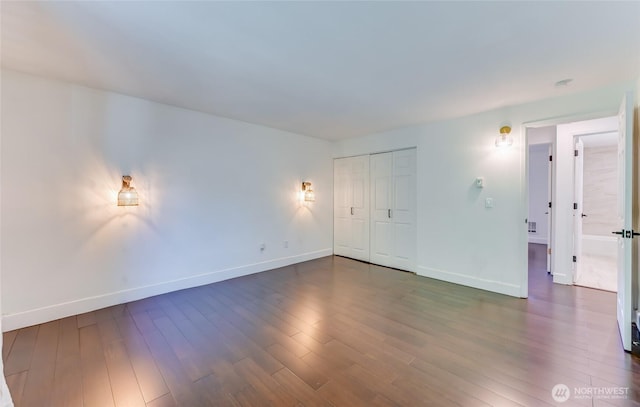 1717 150th Ave SE Unit 18, Bellevue, WA 98007 - unfurnished bedroom featuring dark wood-style flooring and a closet