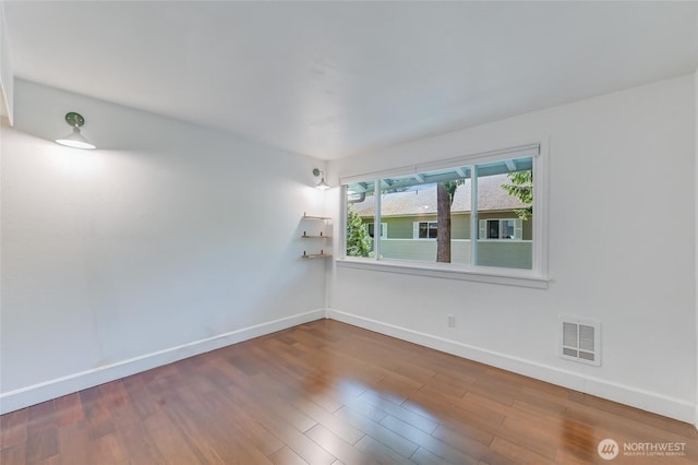 1717 150th Ave SE Unit 18, Bellevue, WA 98007 - spare room with wood finished floors
