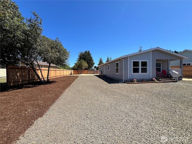 303 N Wynoochee Dr SW, Ocean Shores, WA 98569 - view of home's exterior with a fenced backyard and a porch