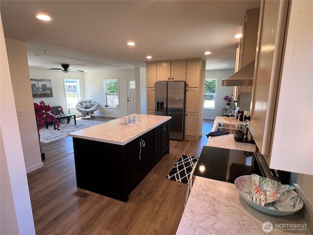 303 N Wynoochee Dr SW, Ocean Shores, WA 98569 - kitchen with stainless steel fridge with ice dispenser, wall chimney exhaust hood, light countertops, a kitchen island, and dark wood-style flooring