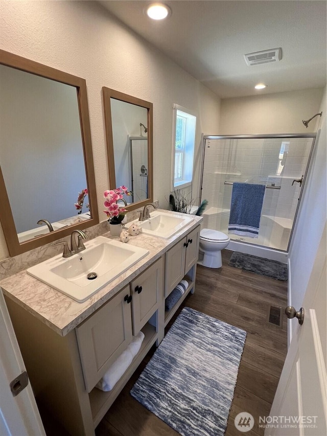 303 N Wynoochee Dr SW, Ocean Shores, WA 98569 - bathroom with a shower stall, double vanity, wood finished floors, and recessed lighting