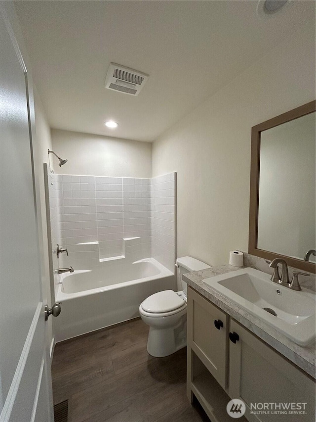 303 N Wynoochee Dr SW, Ocean Shores, WA 98569 - bathroom with wood finished floors, vanity, and shower / bath combination