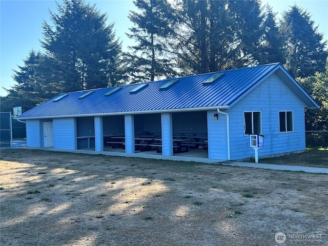 303 N Wynoochee Dr SW, Ocean Shores, WA 98569 - view of side of home featuring a standing seam roof and a metal roof
