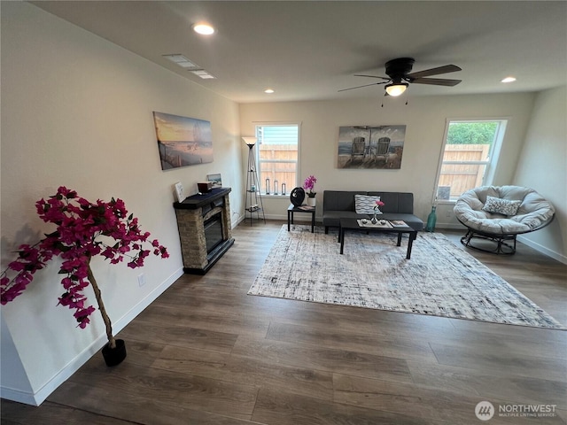 303 N Wynoochee Dr SW, Ocean Shores, WA 98569 - living area featuring healthy amount of natural light, ceiling fan, wood finished floors, recessed lighting, and a glass covered fireplace