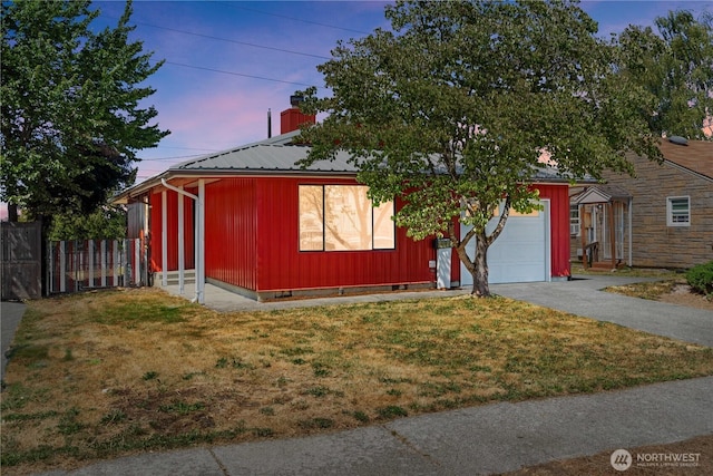 2235 E Wright Ave, Tacoma, WA 98404 - view of front of house featuring asphalt driveway, an attached garage, and a metal roof