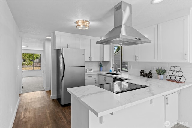 2235 E Wright Ave, Tacoma, WA 98404 - kitchen with island exhaust hood, freestanding refrigerator, a peninsula, backsplash, and dark wood-type flooring