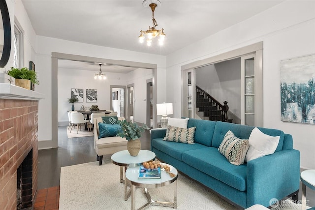 743 Broadway E, Seattle, WA 98102 - living room with a chandelier, dark wood-type flooring, stairs, and a fireplace