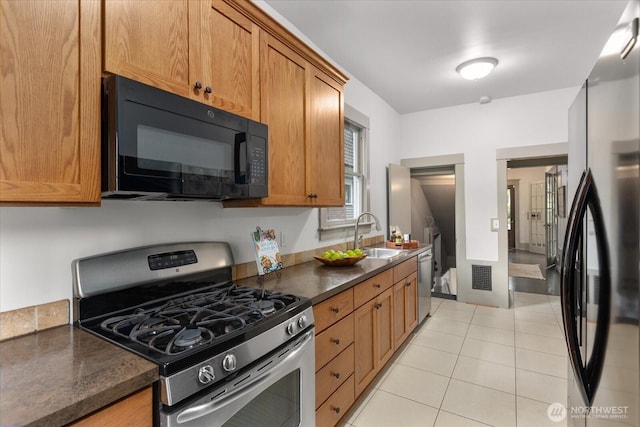 743 Broadway E, Seattle, WA 98102 - kitchen with stainless steel appliances, brown cabinets, and light tile patterned floors