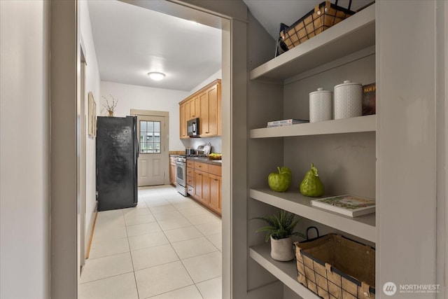 743 Broadway E, Seattle, WA 98102 - kitchen with black appliances, open shelves, dark countertops, light tile patterned flooring, and light brown cabinetry