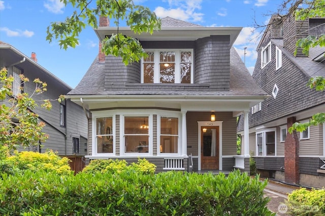 743 Broadway E, Seattle, WA 98102 - view of front of property with a porch, roof with shingles, and a chimney