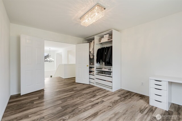 20122 102nd Ave SE, Kent, WA 98031 - unfurnished bedroom with a chandelier, wood finished floors, and a closet