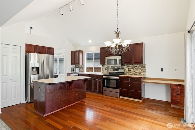 20122 102nd Ave SE, Kent, WA 98031 - kitchen with stainless steel appliances, lofted ceiling, a chandelier, tasteful backsplash, and light countertops