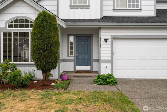 20122 102nd Ave SE, Kent, WA 98031 - view of exterior entry featuring a shingled roof, board and batten siding, and a garage