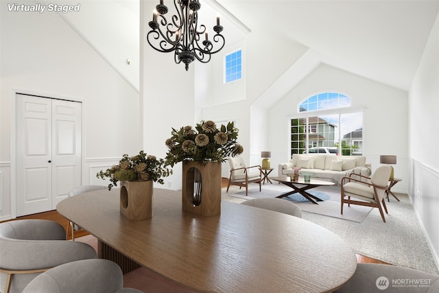 20122 102nd Ave SE, Kent, WA 98031 - dining space featuring high vaulted ceiling, a chandelier, a wainscoted wall, and carpet floors