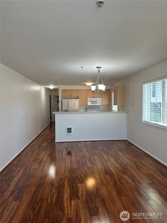 10511 Midvale Ave N Unit 202, Seattle, WA 98133 - kitchen with white microwave, refrigerator with ice dispenser, dark wood finished floors, light countertops, and a peninsula