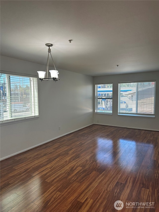 10511 Midvale Ave N Unit 202, Seattle, WA 98133 - unfurnished room featuring a chandelier, dark wood finished floors, and fire sprinkler in ceiling