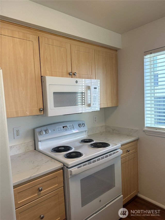 10511 Midvale Ave N Unit 202, Seattle, WA 98133 - kitchen featuring white appliances, healthy amount of natural light, light brown cabinetry, and light stone counters
