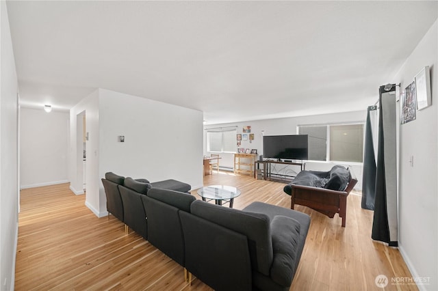 11556 Greenwood Ave N Unit 105, Seattle, WA 98133 - living room with light wood finished floors and a baseboard heating unit