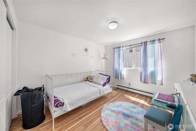 11556 Greenwood Ave N Unit 105, Seattle, WA 98133 - bedroom with baseboard heating and wood finished floors