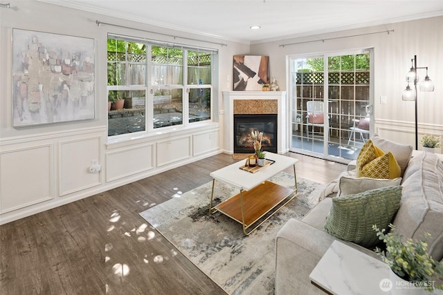 10549 Stone Ave N Unit 101, Seattle, WA 98133 - living area with ornamental molding, wood finished floors, a glass covered fireplace, and recessed lighting