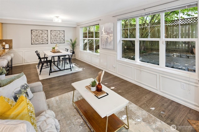 10549 Stone Ave N Unit 101, Seattle, WA 98133 - living area with a decorative wall, crown molding, wood finished floors, and a wainscoted wall