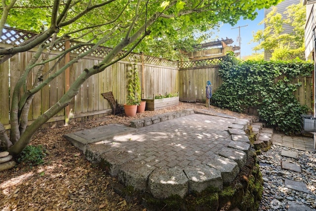 10549 Stone Ave N Unit 101, Seattle, WA 98133 - fenced backyard featuring a patio area