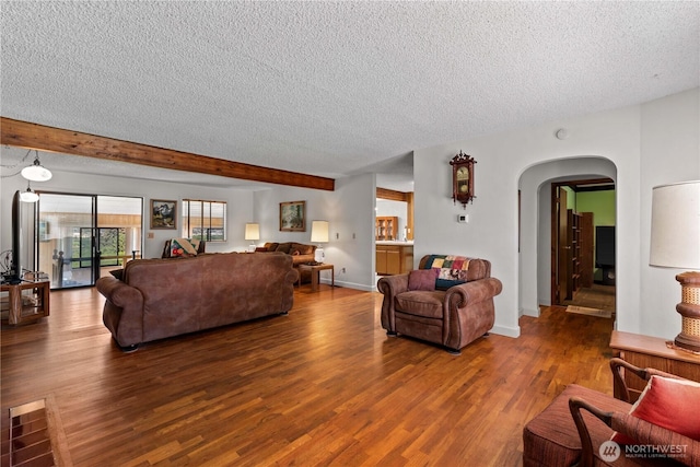 2434 NW Alan Ave, East Wenatchee, WA 98802 - living room featuring a textured ceiling, arched walkways, wood finished floors, and beam ceiling