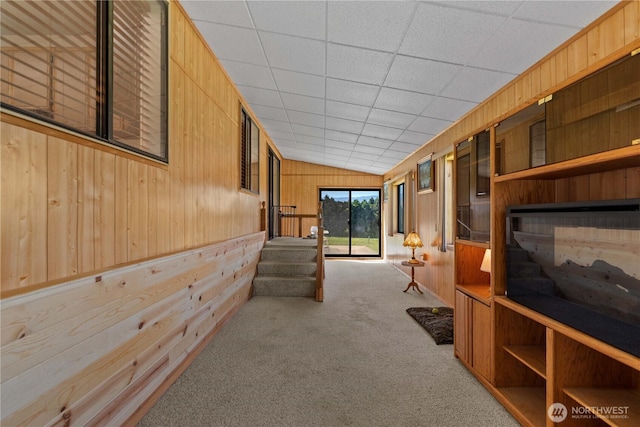 2434 NW Alan Ave, East Wenatchee, WA 98802 - hallway with wood walls, carpet floors, and lofted ceiling