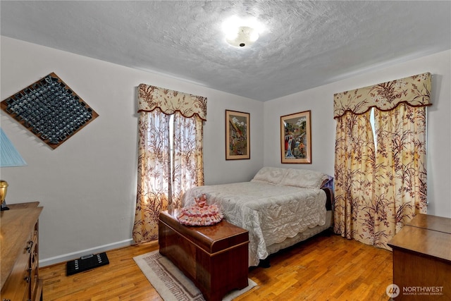 2434 NW Alan Ave, East Wenatchee, WA 98802 - bedroom featuring light wood-type flooring and a textured ceiling