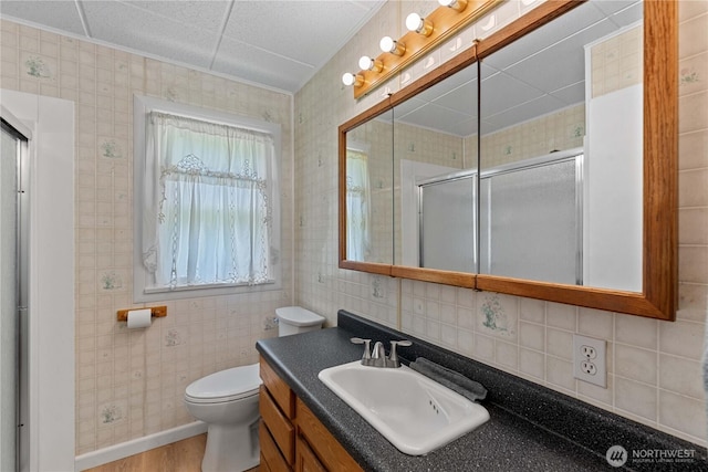 2434 NW Alan Ave, East Wenatchee, WA 98802 - bathroom with a shower stall, vanity, decorative backsplash, and wood finished floors