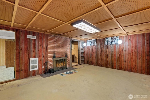 2434 NW Alan Ave, East Wenatchee, WA 98802 - finished below grade area with wooden walls, heating unit, and a fireplace