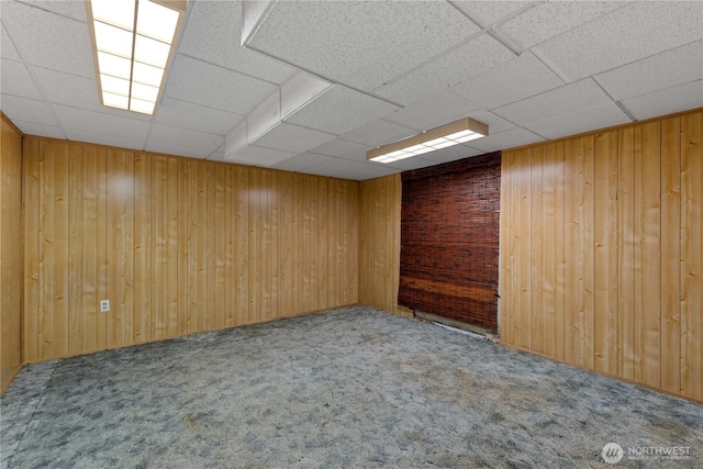 2434 NW Alan Ave, East Wenatchee, WA 98802 - carpeted empty room featuring a paneled ceiling and wooden walls